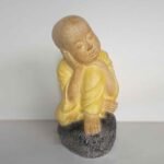 Shaolin statue brooding on stone