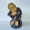 Shaolin statue sleeping on stone