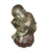 Shaolin statue sleeping on stone